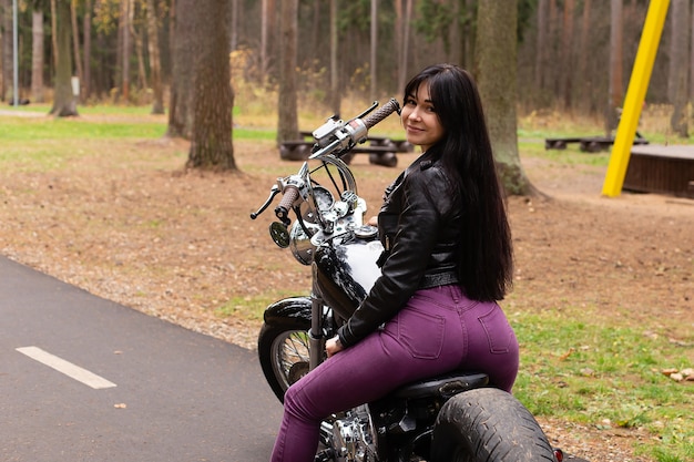 The beautiful brunette on a motorcycle