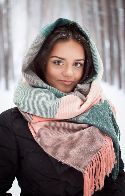 Beautiful brunette stands in a winter forest