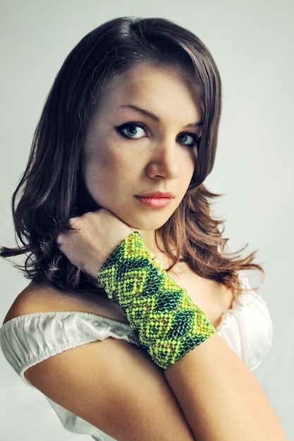 Beautiful brunette in the wide bracelet from the beads