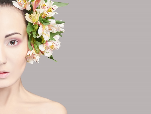 Beautiful brunette with flowers on his head makeup