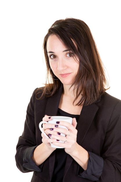 Beautiful brunette woman drinks a coffee or tea in a mug