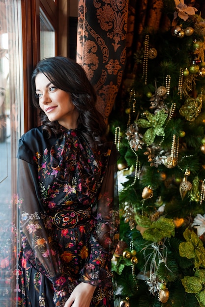 Beautiful brunette woman near window