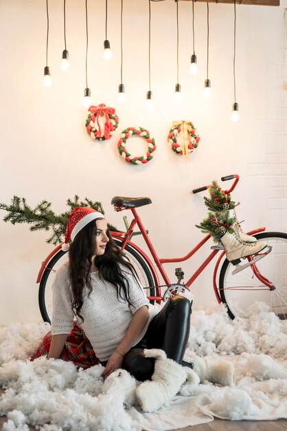 Beautiful brunette woman posing at christmas studio