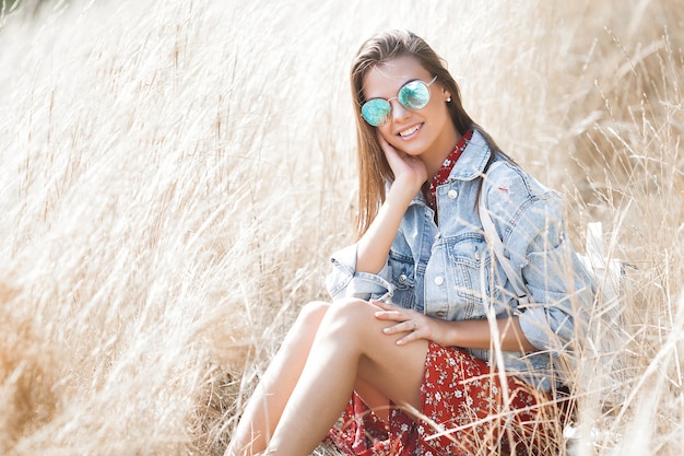 Beautiful brunette woman posing in the wheat field