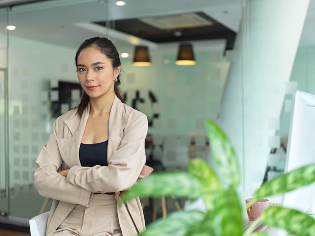 Photo beautiful brunette woman sitting in her office