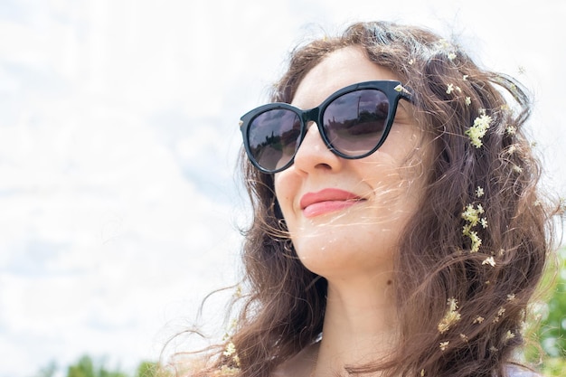 Beautiful brunette woman smiling in sunglasses