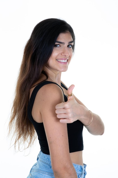 Beautiful brunette woman with hand thumb up success sign positive gesture smile and happiness over isolated white background