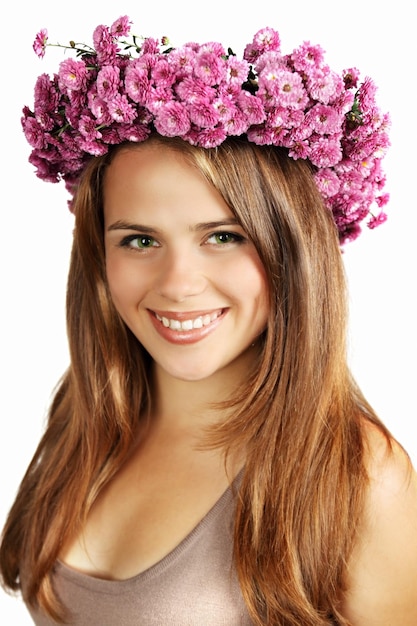 Beautiful brunette in a wreath of chrysanthemums