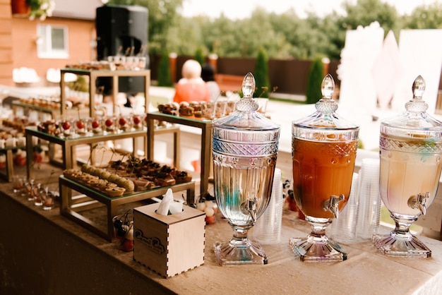 Beautiful buffet for guests at the event lemonades in glass bottles