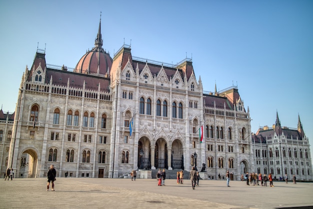 Beautiful building of the Hungarian paliament built in the gothic revival architectural style on a background of clear blue sky in Budapest, Hungary.