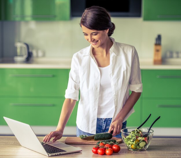 Beautiful business girl is using a laptop and smiling.