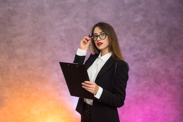 Beautiful business lady pointing with pen on clipboard proposing sign a contract