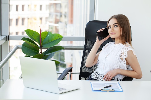 Beautiful business lady working with laptop in office