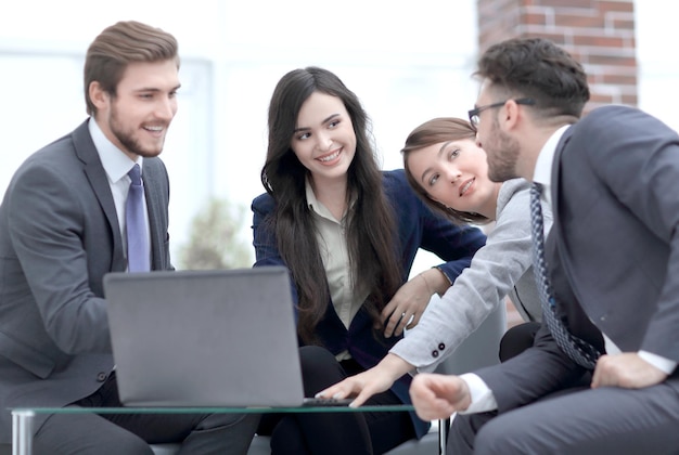 Beautiful business people are using a laptop during the conferen