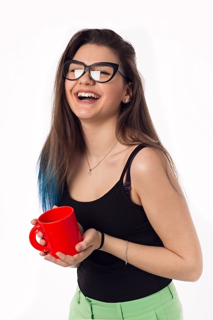 Beautiful business woman drinking coffee tea from a red cup. portrait. Office worker.