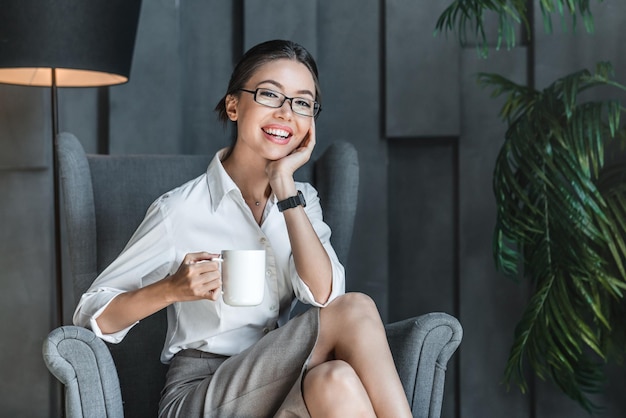 Beautiful business woman drinking coffee