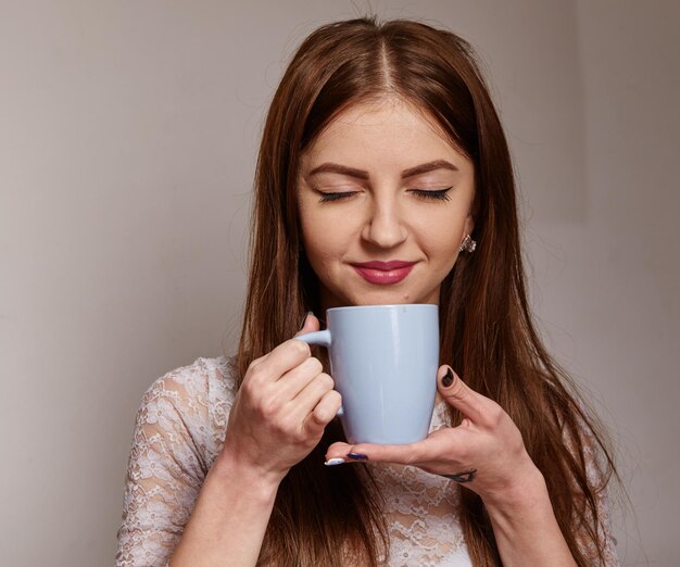 A beautiful business woman enjoying a cup of tea at the workplace