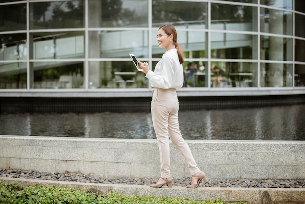 Beautiful business woman is working outside office 