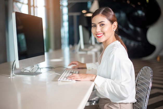 Beautiful business woman is working with her computer 