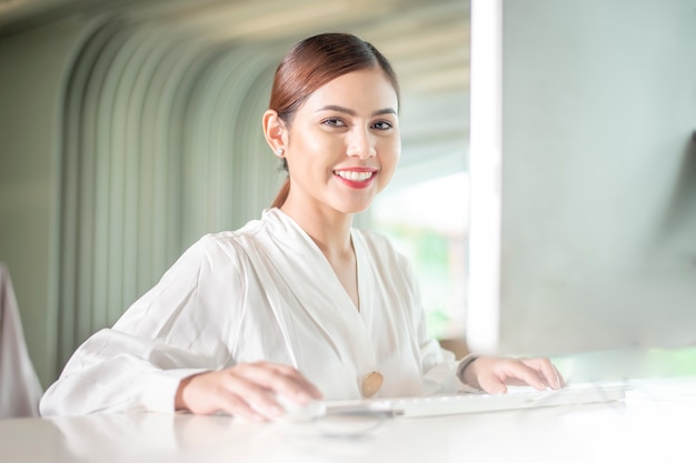 Beautiful business woman is working with her computer 