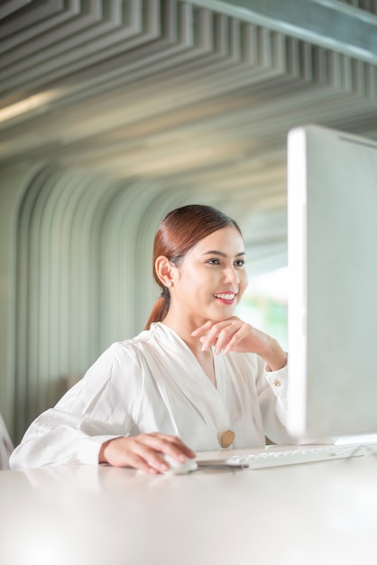 Beautiful business woman is working with her computer 