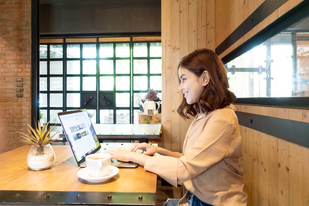 Beautiful business woman is working with her laptop in coffee shop 