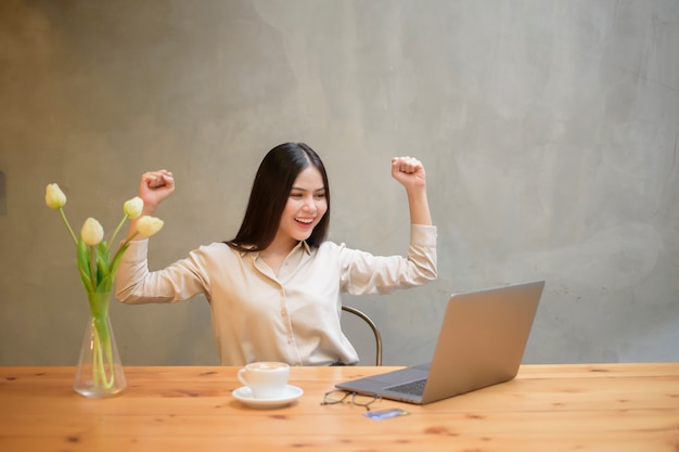 Beautiful business woman is working with laptop in coffee shop