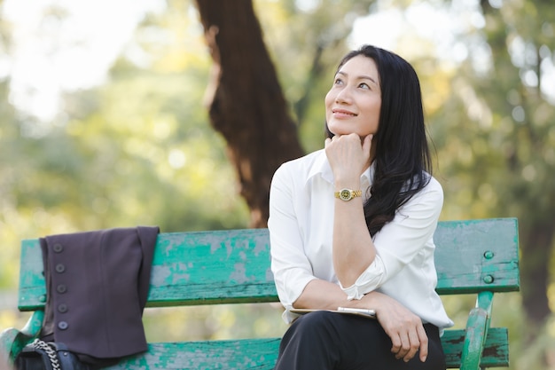 Beautiful business woman in park