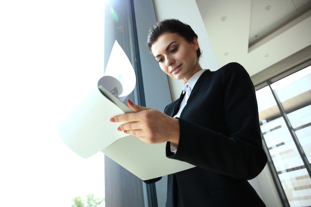 Beautiful business woman smiling in a modern office