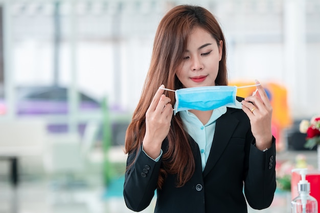 beautiful business woman wearing a mask after the covid-19 virus spread to prevent the spread of germs and bacteria and avoid coronary heart disease.