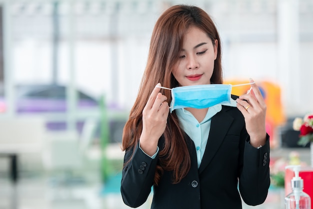 Beautiful business woman wearing a mask after the covid-19 virus spread to prevent the spread of germs and bacteria and avoid coronary heart disease.