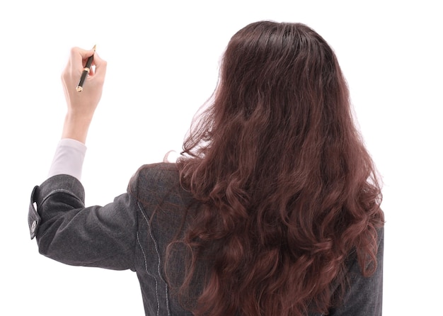 Beautiful business woman on a white background writing on the wall advertising text