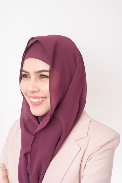 Beautiful business woman with hijab portrait on white wall