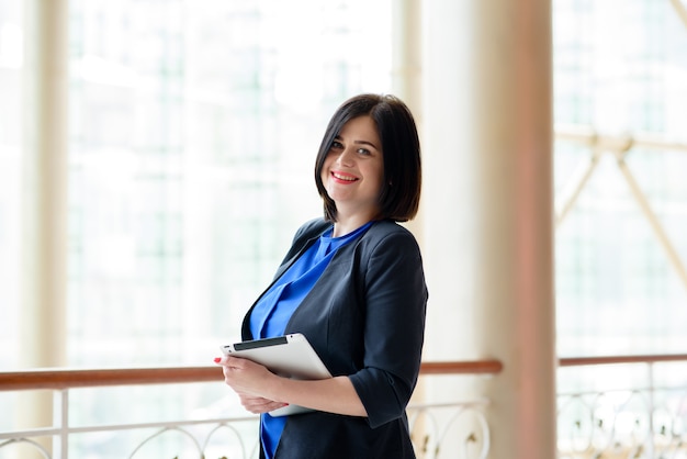 Beautiful business woman with the tablet.