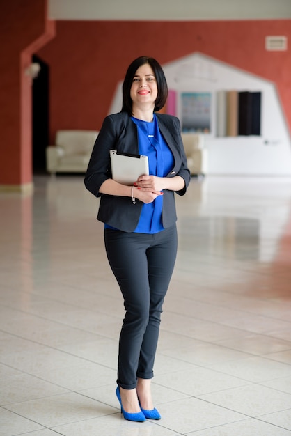 Beautiful business woman working with laptop and tablet.