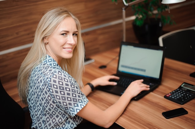 Beautiful business woman working with sales in her office.