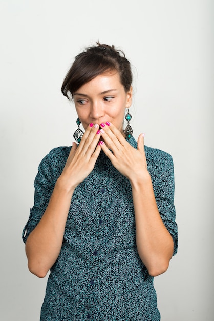 beautiful businesswoman against white wall