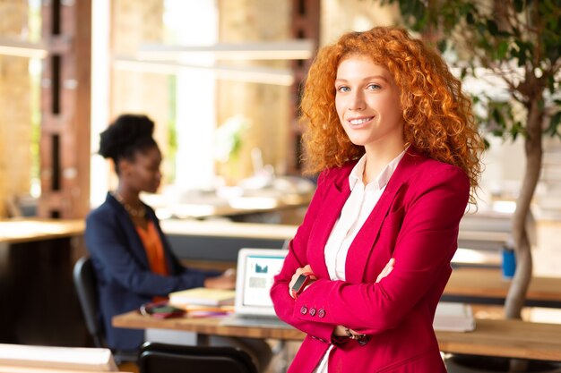 Beautiful businesswoman. Beautiful businesswoman wearing pink jacket feeling motivated and excited