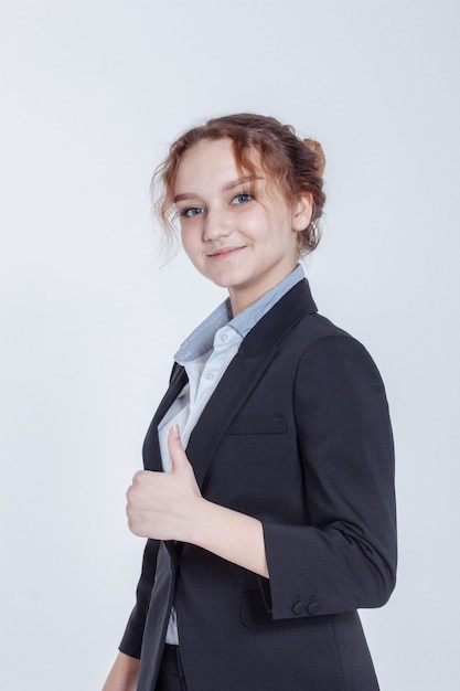 Beautiful businesswoman in classic elegant suit showing thumb-up gesture on white