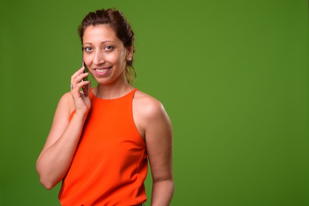 Beautiful businesswoman on green