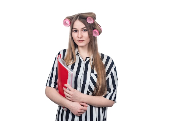 beautiful businesswoman in hair rollers holding a folder with documents under her arm isolated on white background