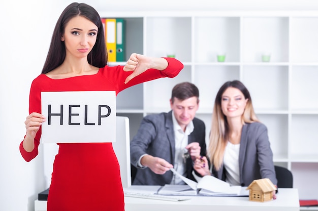 Beautiful businesswoman at office asks of the help