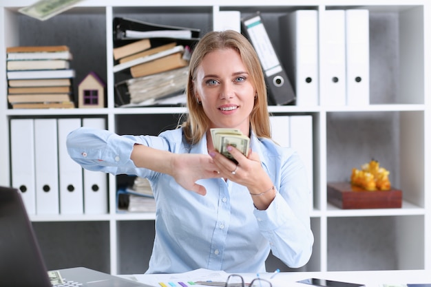 Beautiful businesswoman portrait. Scattering money