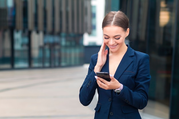 beautiful businesswoman standing outdoors business center