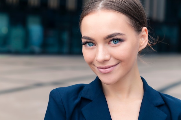 beautiful businesswoman standing outdoors business center