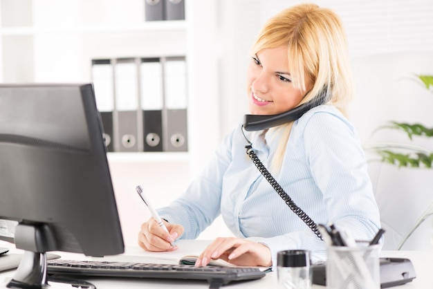 Photo beautiful businesswoman telephoning and working in the office.