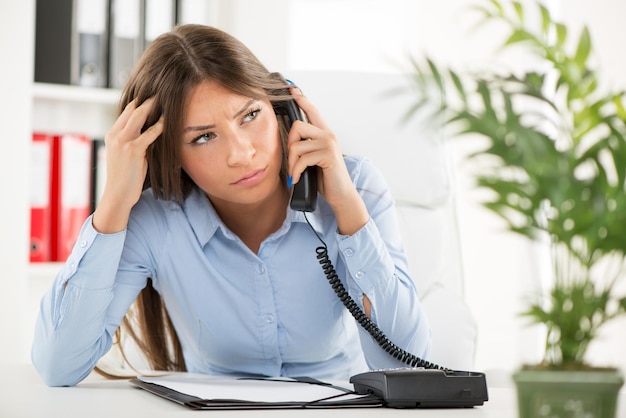 Beautiful Businesswoman telephoning and working in the office.