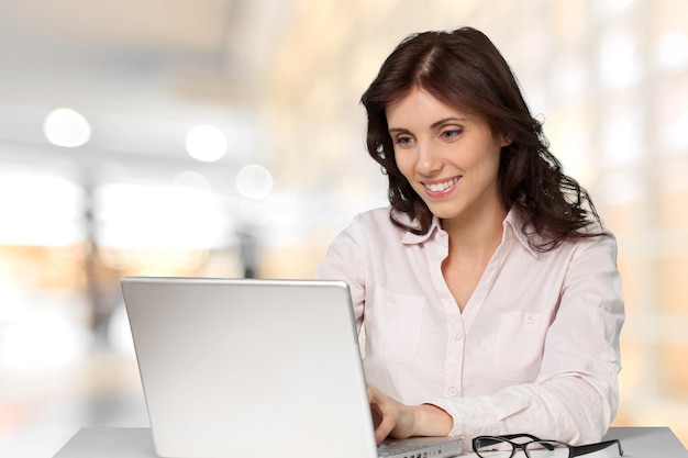 Beautiful businesswoman using laptop isolated on white