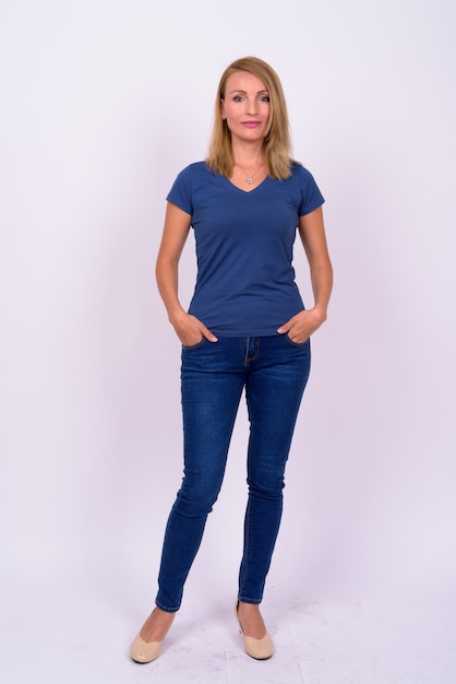  beautiful businesswoman with blond hair wearing blue shirt against white wall