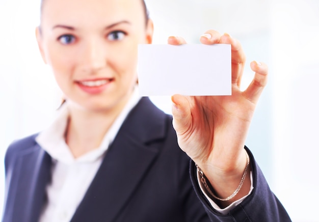 Beautiful businesswoman with the business card in the office